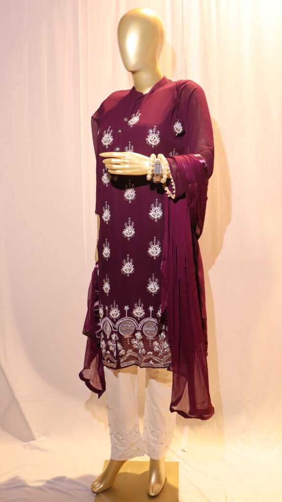 mannequin wearing wine colour dress which has pearl hand embroidery on it and wine colour dupatta and white pant