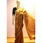 mannequin wearing a Golden colour saree