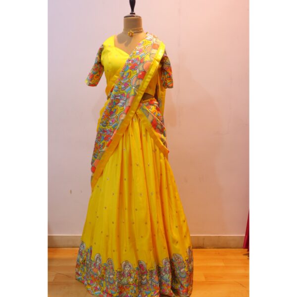 Mannequin wearing yellow kalamkari lehenga blouse designs made with traditional kalamkari fabric