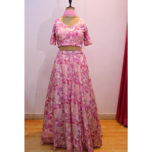 Blush pink floral lehenga crafted from designer fabric, paired with a matching designer blouse and a lightweight georgette dupatta, perfect for weddings, engagements, and festive celebrations.